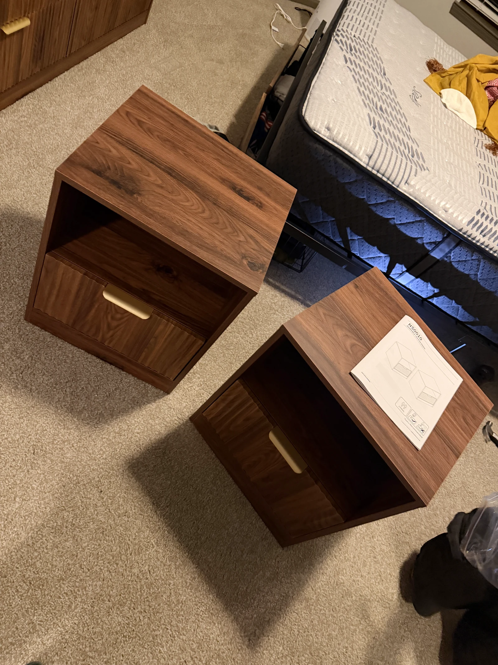 Two assembled brown nightstands with brass-colored handles