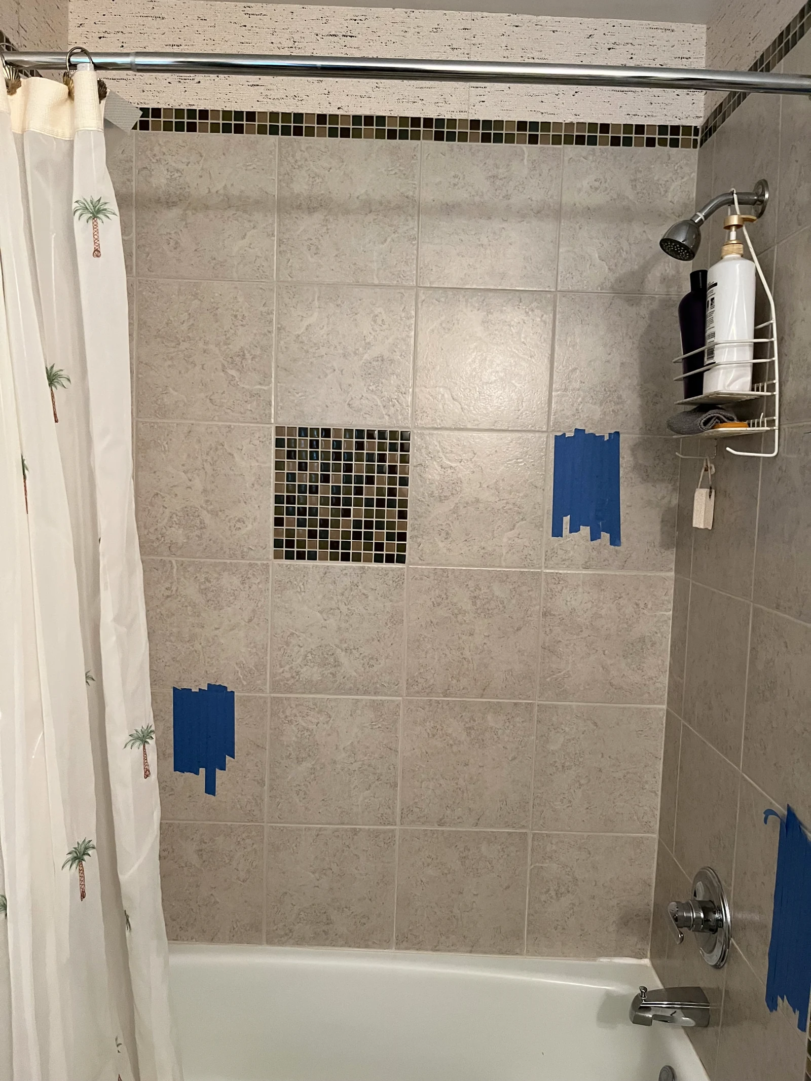 Bathroom tile with blue tape marking planned grab-bar mounting points
