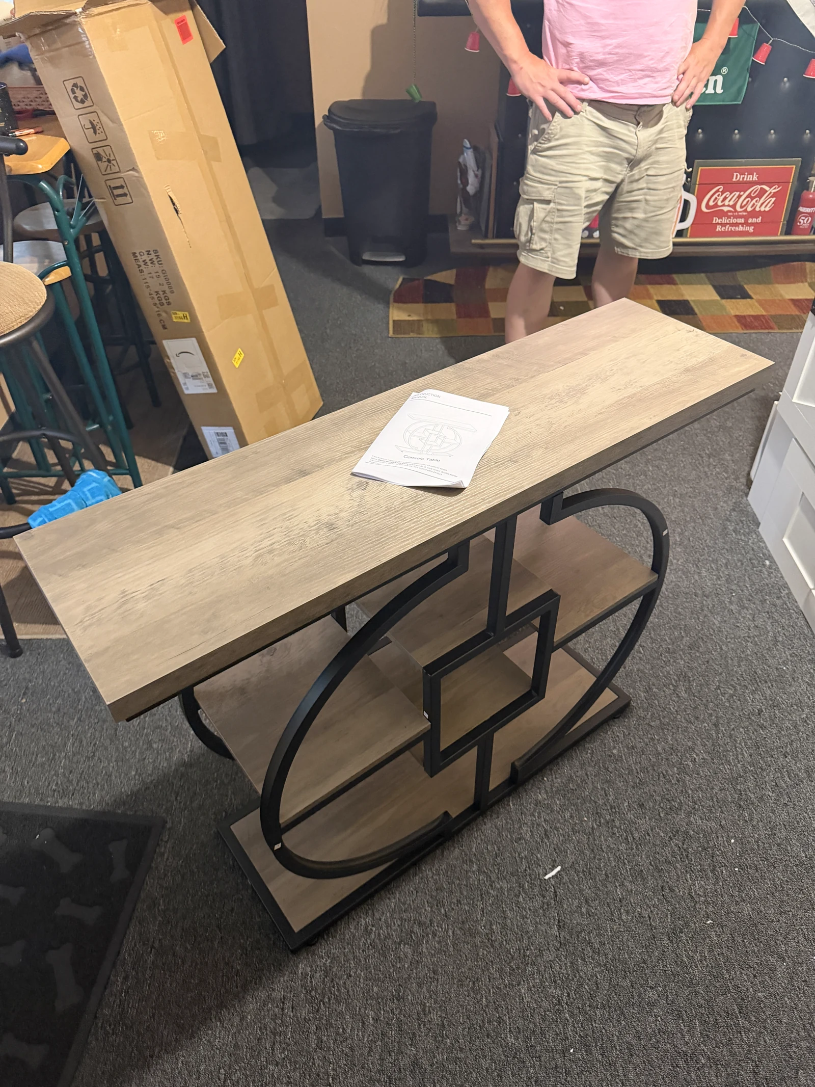 Assembled wood console table with a circular black metal frame
