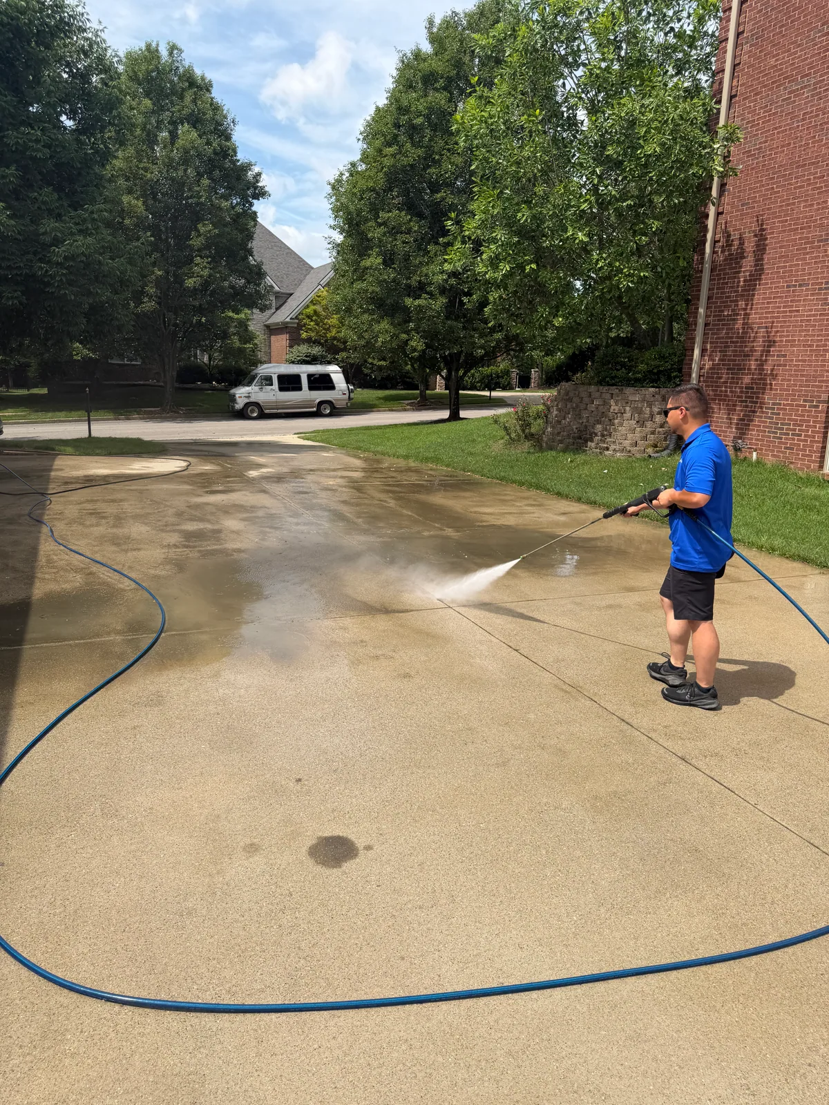 Arorix technician rinsing a residential concrete driveway in Georgetown Kentucky