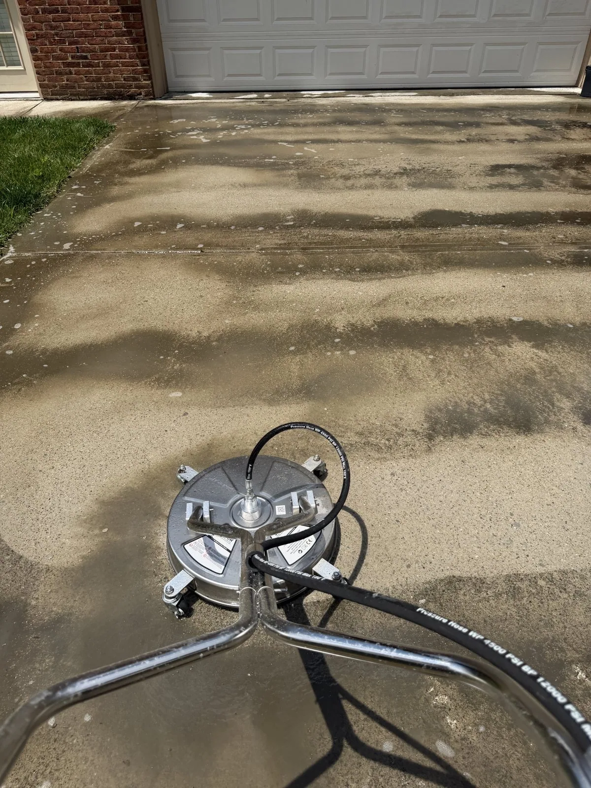 Surface cleaner in use on a residential concrete driveway during an Arorix project in Lexington Kentucky