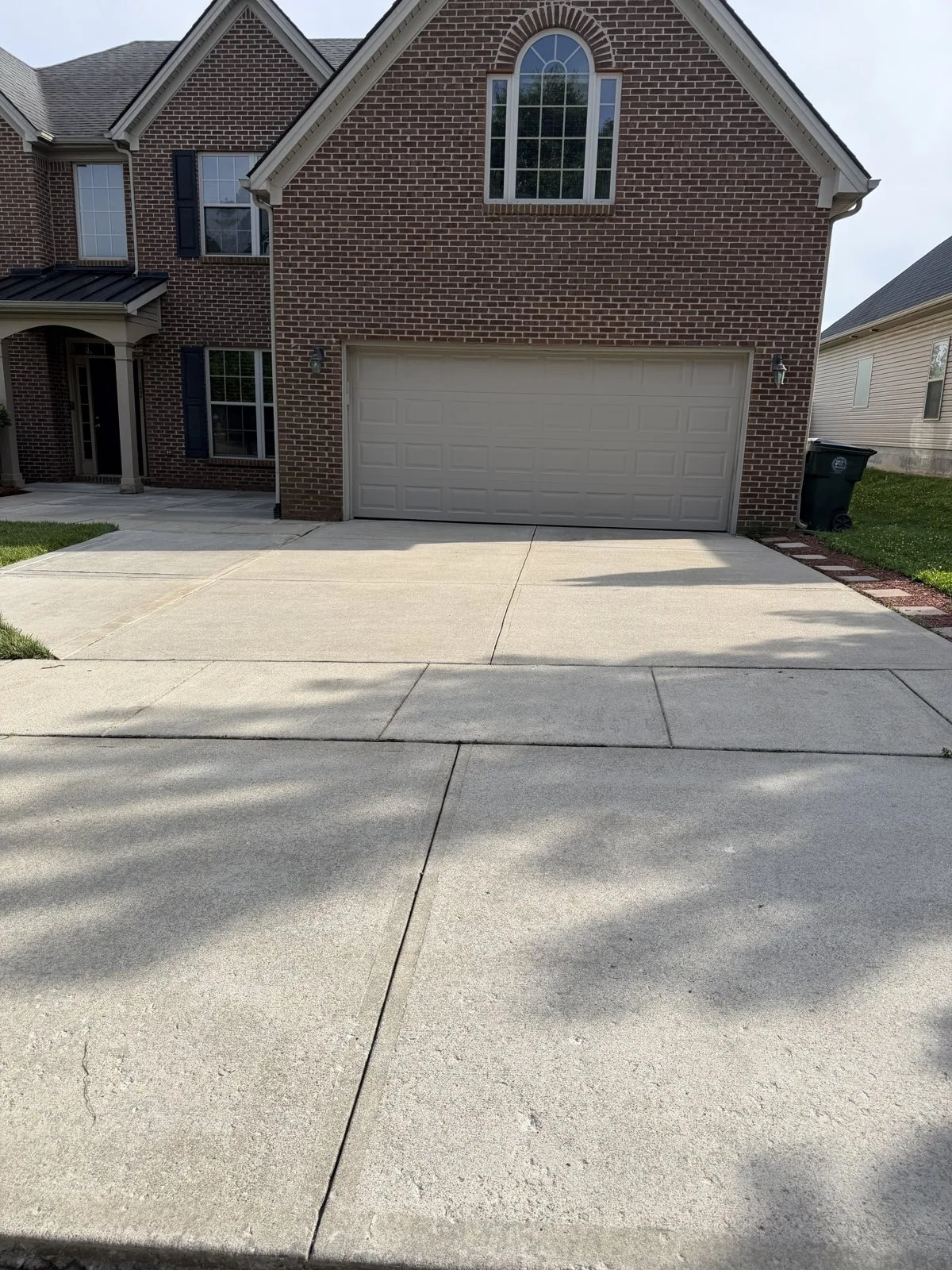 Lexington home and driveway after exterior cleaning by Arorix Home Solutions