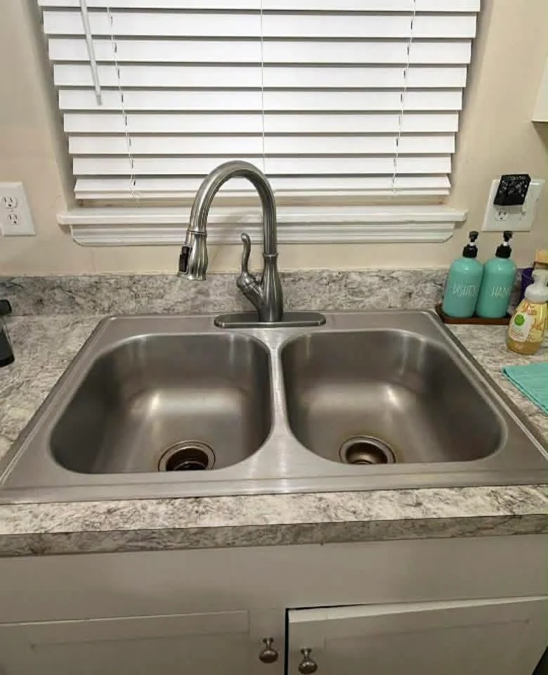 Original stainless steel double-bowl kitchen sink before replacement