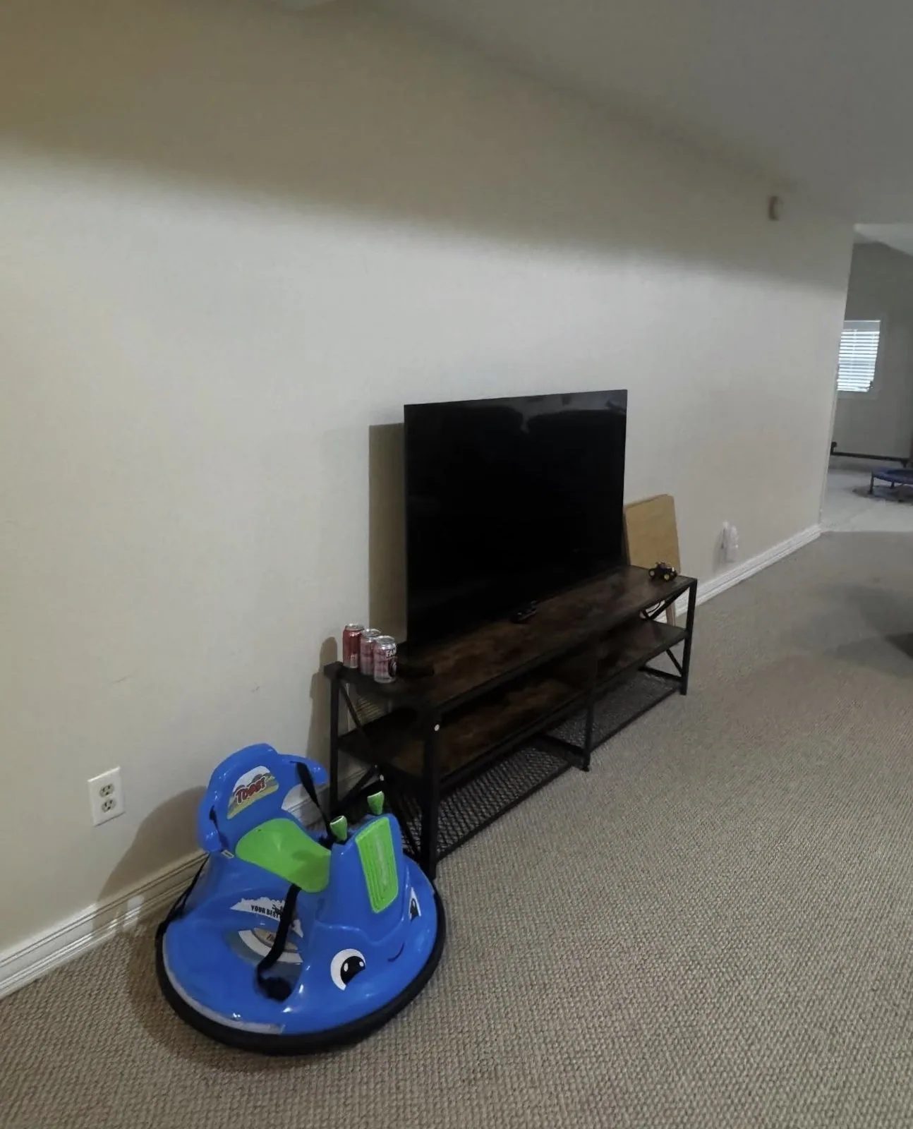 Television resting on a media console before wall mounting in Lexington Kentucky